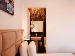 a bathroom with a sink and a mirror at Hotel Keli in Ksamil