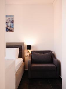 a bedroom with a bed and a chair at Hotel Keli in Ksamil