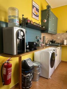 a kitchen with a counter with a washer and dryer at Oscar - City Center Rooms Athens in Athens