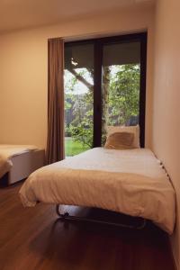 a bed in a room with a large window at Huyze Fox - Boutique Stays in Bruges +66 photos