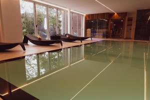 an infinity pool with chairs in the middle of a house at Huyze Fox - Boutique Stays in Bruges
