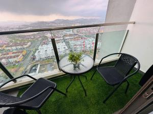 a table and chairs on a balcony with a view at Evo studio soho mini apartment in Bandar Baru Bangi