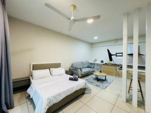 a bedroom with a bed and a chair and a ceiling fan at Evo studio soho mini apartment in Bandar Baru Bangi