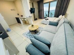 a living room with a blue couch and a table at Evo studio soho mini apartment in Bandar Baru Bangi