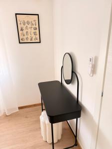 a black desk with a mirror on a wall at Novelli Homes in Formigine