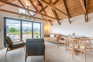 a living room with a table and a couch at 2 Bed in Blakeney oc-m42455 in Awre