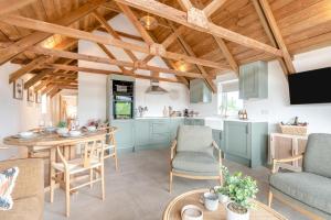 a kitchen and living room with a table and chairs at 2 Bed in Blakeney oc-m42455 in Awre