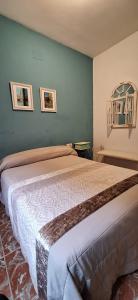 a bedroom with a bed and two pictures on the wall at Eclipse del Júcar Luna in Alcalá del Júcar