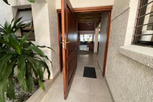 a door leading to a hallway with a plant at SeaWaves Beach House, Shelly Beach in Shelly Beach