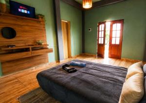 a bedroom with a bed and a tv in a room at Bosque da Lua - Suite with 2 bathrooms - Up to 5 guests in Itupeva