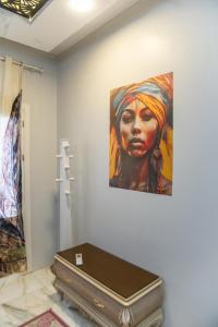 a painting of a woman on a wall with a suitcase at New Villa Carimo in Quseir +108 photos