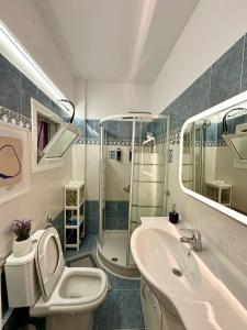a bathroom with a toilet and a sink and a shower at Oscar - City Center Rooms Athens in Athens +106 photos