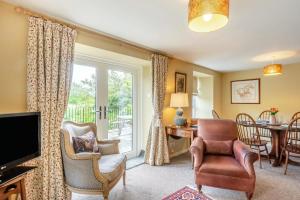 a living room with a chair and a television at 3 Bed in Coldstream oc-c39085 in Coldstream