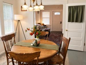 a dining room table with a vase of flowers on it at Mt Shasta Basecamp in Dunsmuir +10 photos