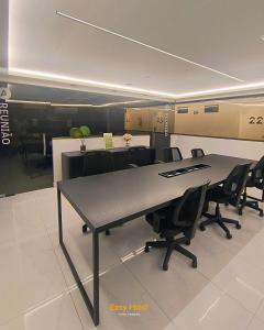 a conference room with a large table and chairs at Flats Unity Cabo Branco - By EasyHost in João Pessoa +32 photos