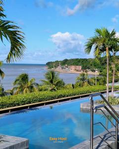 a view of the ocean from the balcony of a resort at Flats Unity Cabo Branco - By EasyHost in João Pessoa