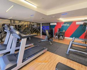 a gym with treadmills and exercise equipment in a room at Flats Unity Cabo Branco - By EasyHost in João Pessoa