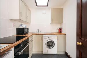 a kitchen with a washer and dryer in it at 2 Bed in Thurleigh oc-o42689 in Thurleigh