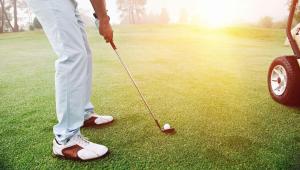 a man is playing golf on a golf course at Relax Inn Bloomsburg in Bloomsburg