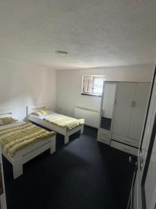 a room with two beds and cabinets and a window at Villa Dani in Bihać +7 photos