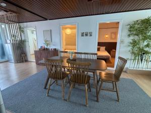 a dining room with a table and chairs and a bedroom at Coco House in Daejeon