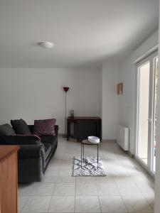 a living room with a couch and a table at le chardonneret in Commer +1 photo