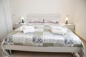 a bedroom with a bed with a quilt and pillows at Bed And Breakfast Nonna Pia in Fertilia