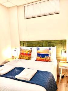 a bedroom with a bed with two pillows on it at The Lazy Expat - Paarl - Self Catering Apartment in Paarl