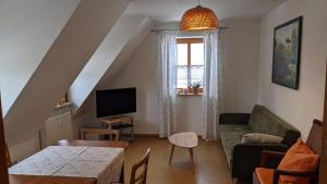 a living room with a couch and a table at Ferienwohnung Abel in Heideck