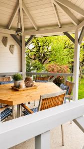 a wooden table and chairs on a patio at EulenNest - Ferienhaus in Seeboden am Millstätter See mit Bergblick & Sauna in Seeboden