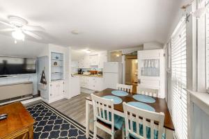 a kitchen with a table and chairs and a dining room at Old Orchard Cottage in Old Orchard Beach