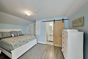 a bedroom with a bed and a dresser in it at Old Orchard Cottage in Old Orchard Beach