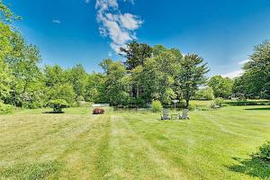 two chairs in the middle of a grass field at Old Orchard Cottage in Old Orchard Beach
