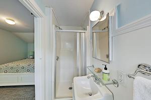 a bathroom with a sink and a shower with a bed at Old Orchard Cottage in Old Orchard Beach +27 photos