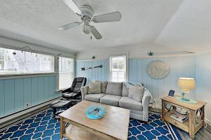 a living room with a couch and a table at Old Orchard Cottage in Old Orchard Beach