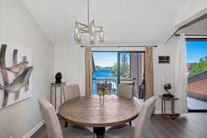 a dining room with a wooden table and chairs at Village Lakefront Paradise in Lake Arrowhead