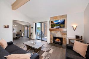 a living room with a couch and a fireplace at Village Lakefront Paradise in Lake Arrowhead +38 photos