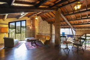 a living room with a couch and chairs at Villa Terrarossa with Pool in the Vineyard in Mezzane di Sotto