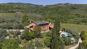 an aerial view of a house in a vineyard at Villa Terrarossa with Pool in the Vineyard in Mezzane di Sotto