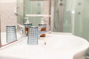 a bathroom sink with a faucet and a mirror at Bed And Breakfast Nonna Pia in Fertilia +46 photos