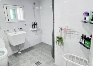 a white bathroom with a sink and a toilet at Coco House in Daejeon +52 photos