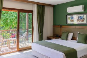 a bedroom with a bed and a balcony at WEST HOUSE EXCLUSIVE HOTEL in Göcek +112 photos