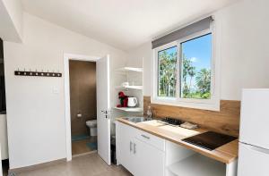 a white kitchen with a sink and a window at Smart Deluxe Studio N9 private Kitchenette Balcony Beach 250m Marina Port 900m in Limassol