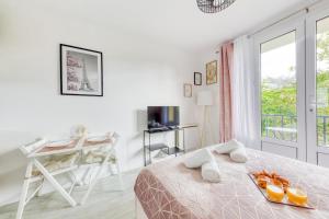 a white bedroom with a bed and a desk and a window at Parking free - cosy & elegant in LʼHay-les-Roses