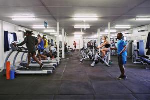 a group of people exercising in a gym at Capricorn Village in Newman
