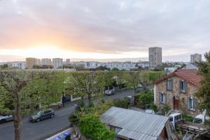 a view of a street in a city with buildings at Parking free - cosy & elegant in LʼHay-les-Roses