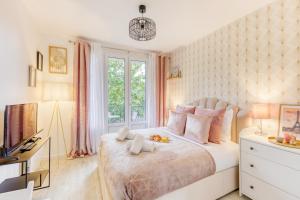 a bedroom with a large bed with a window at Parking free - cosy & elegant in LʼHay-les-Roses