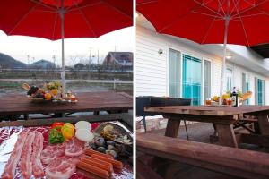 a picnic table with food and a red umbrella at Buan Solseom House Pension in Buan