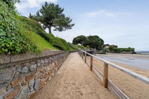 a stone wall next to the beach at Chambre D'hôtes - Chambre Marine in La Plaine-sur-Mer