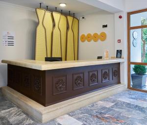 a store counter with surfboards on the wall at Fun Sun Smart Akman Beach in Kemer +48 photos